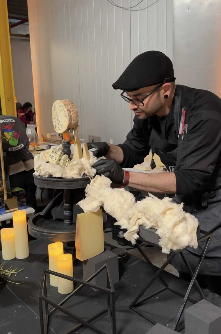 Tommy building a competition cheese display wrapped in pulled curd